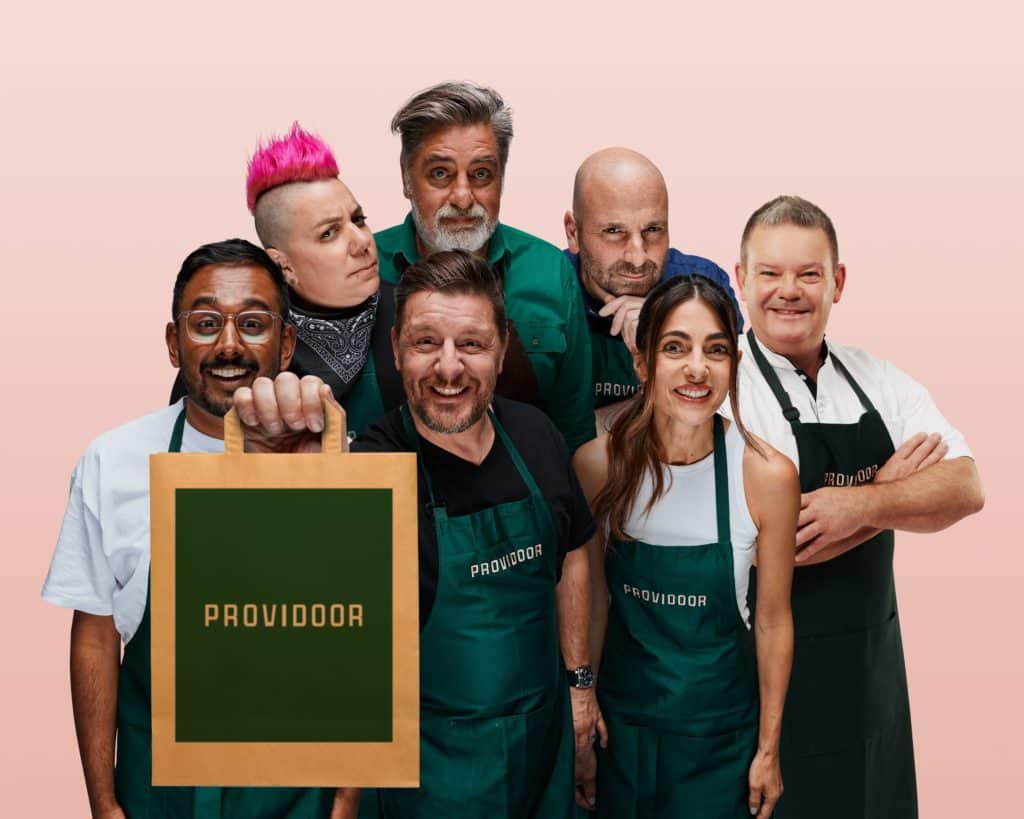 notable chefs, with Manu  Feildel holding a Providoor takeaway bag