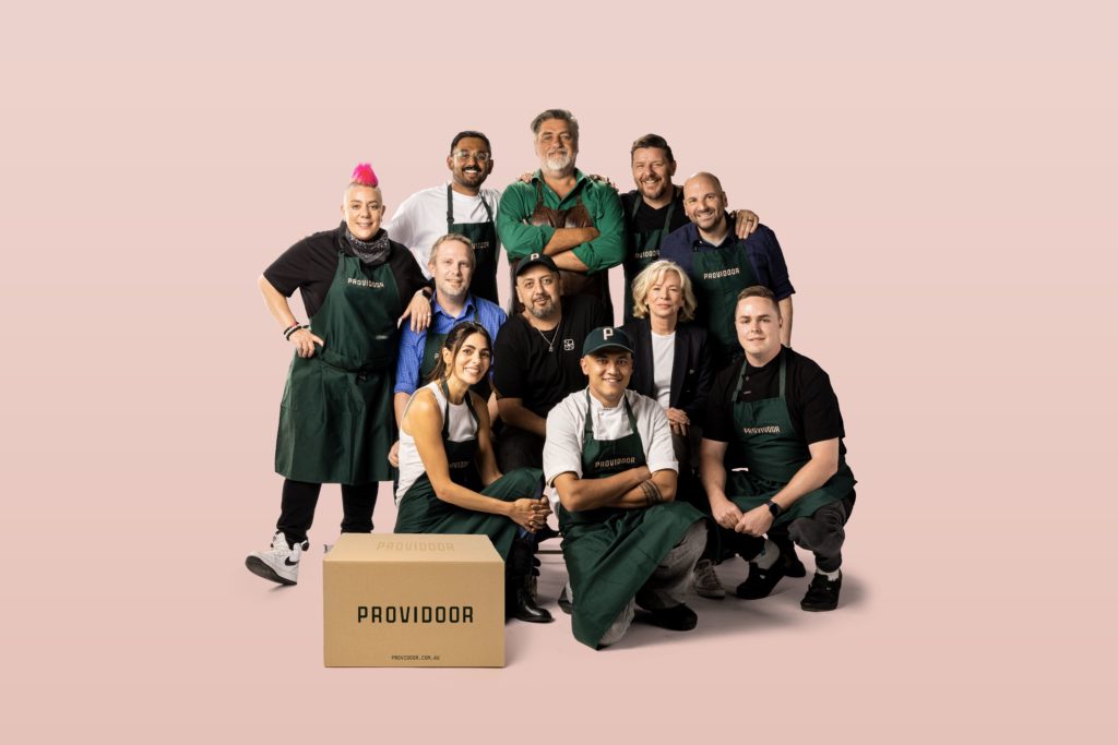 a group of famous chefs and food personalities in front of posing behind a Providoor box