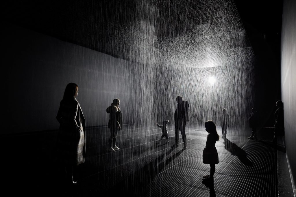 people standing inside the Rain Room