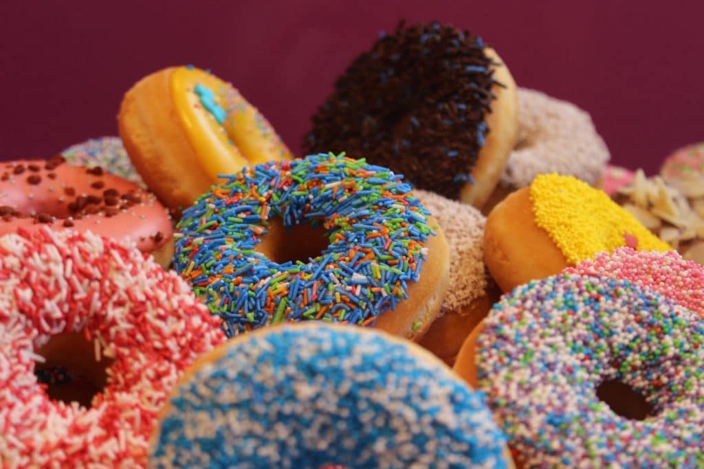 a close-up of colourful, sprinkled donuts to get you excited for the donut festival