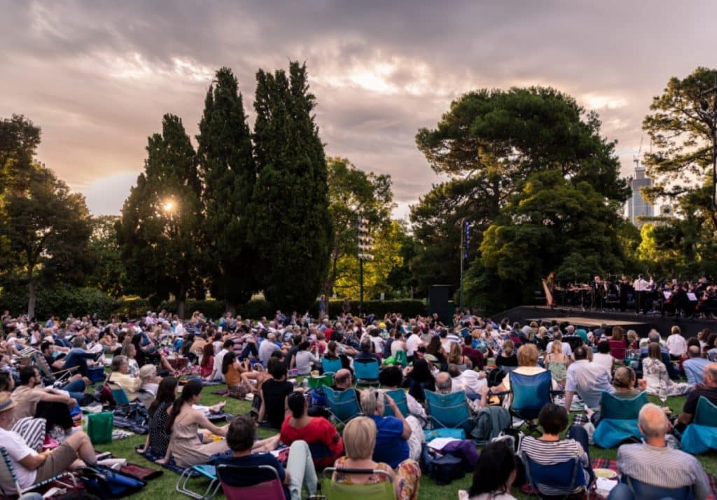 audiences watching a performance at Shakespeare Under The Stars