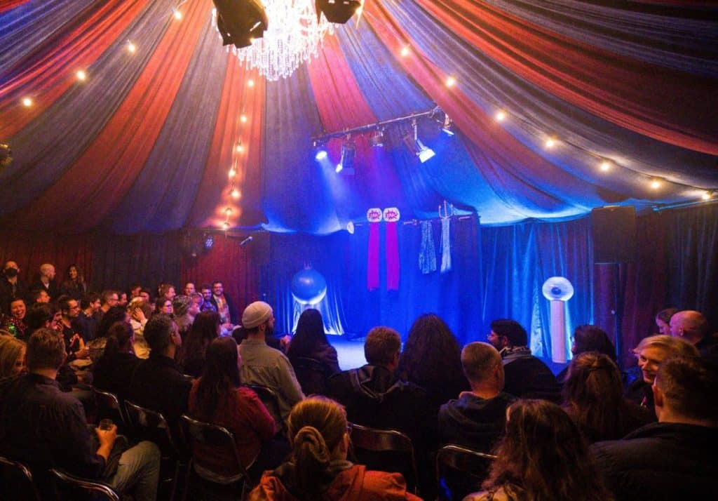 an audience inside a circus tent