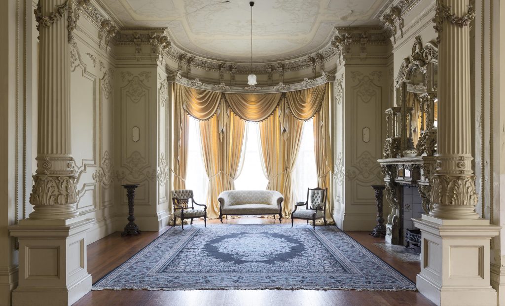 main room at labassa mansion with huge windows and giant rug