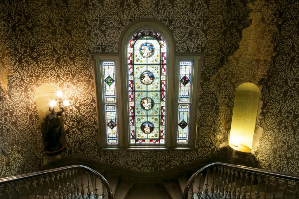 stairway and stained glass windows of labassa mansion