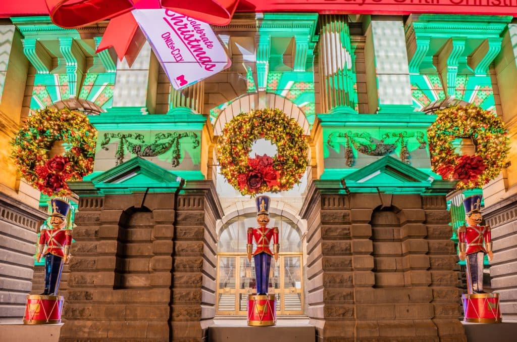once of the things you can do in Melbourne this Christmas is see projections and a nutcracker soldier at Melbourne Town Hall