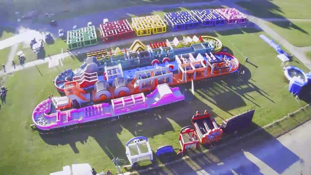 inflatable fun park set up with giant maze, pools, obstacle courses and water zones