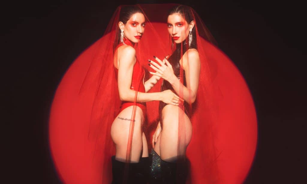 Sisters Jess and Lisa Origliasso, otherwise known as The Veronicas in red outfits