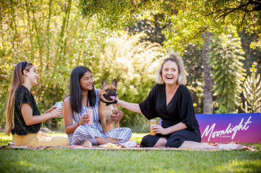 laughing women with a smiling dog at Moonlight Cinema