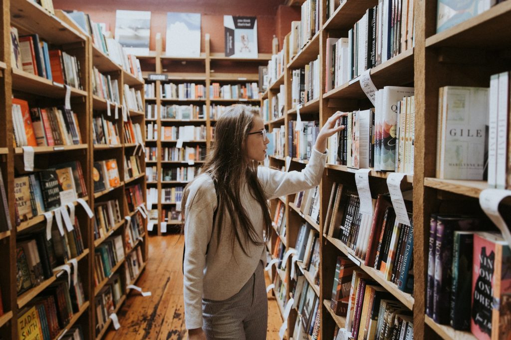 woman browsing for books in a library