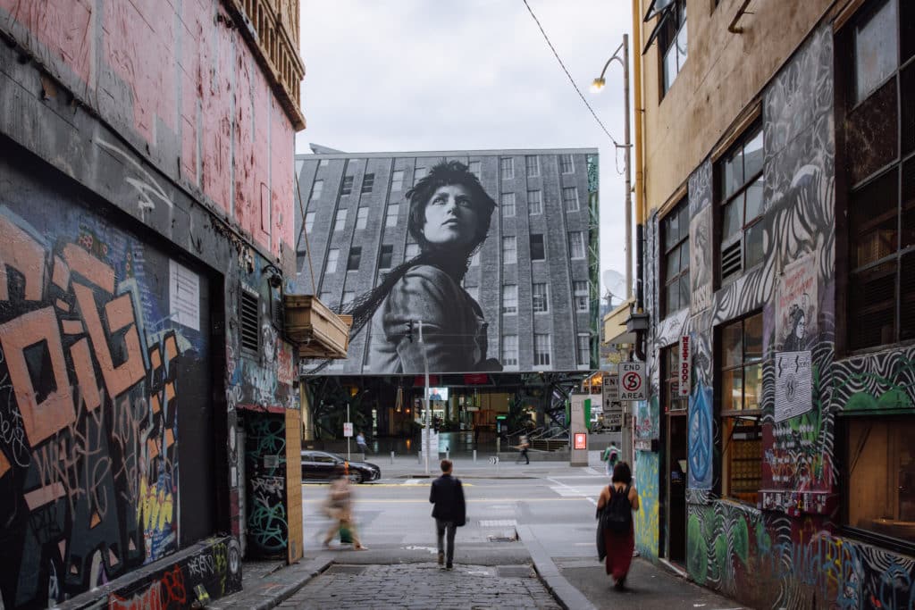 massive photo taking up a whole building facade, seen from a Melbourne laneway