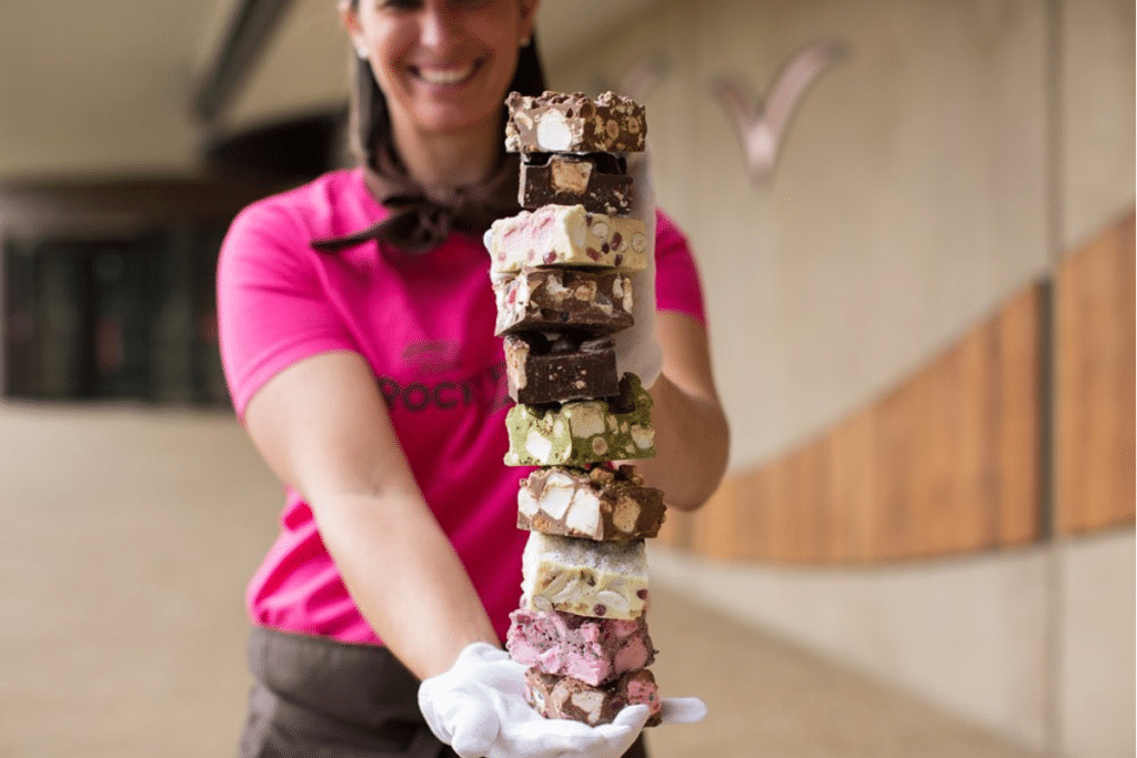 a woman holding a tower of rocky roads for the rocky road festival