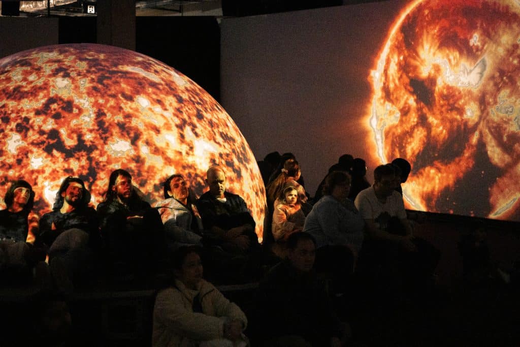 cinema projection of mars or the sun at neighbourhood earth