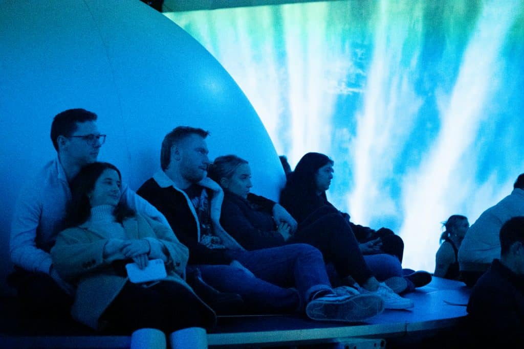 group of people watching space cinema experience at neighbourhood earth