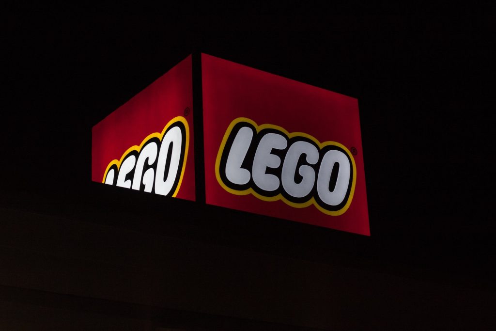 red and white LEGO cube sign amid black background