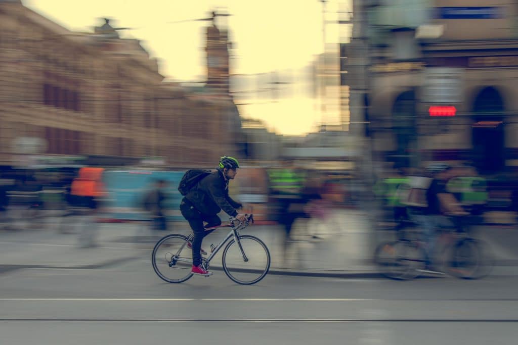 man communiting by bike to work on Flinders Street, Melbourne