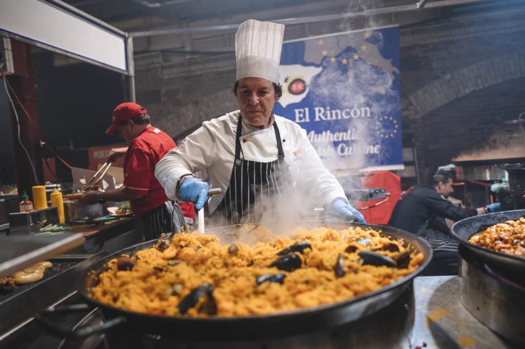 a woman cooking paella