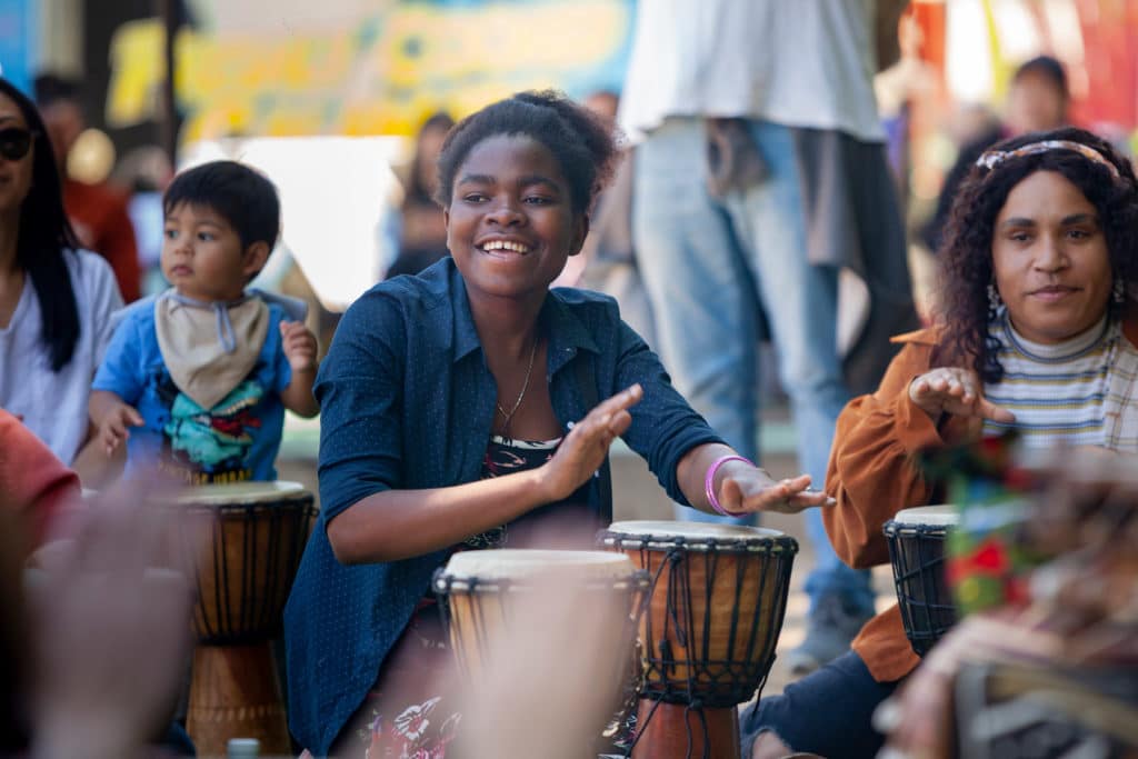 smiling girl playing drums