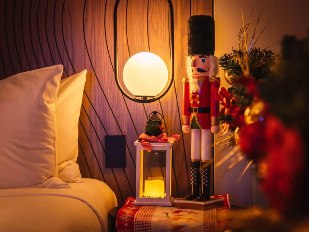 a Christmas nutcracker and a lantern next to a bed at DoubleTree by Hilton Melbourne