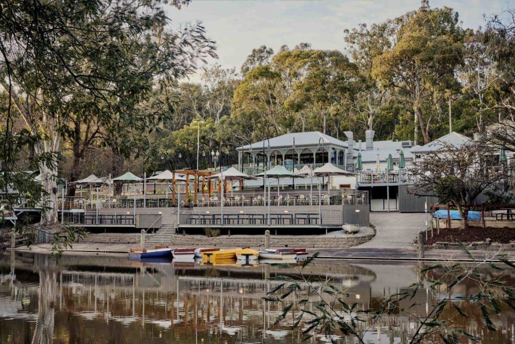 A view of Studley Park Boathouse from across the river with the boats in view
