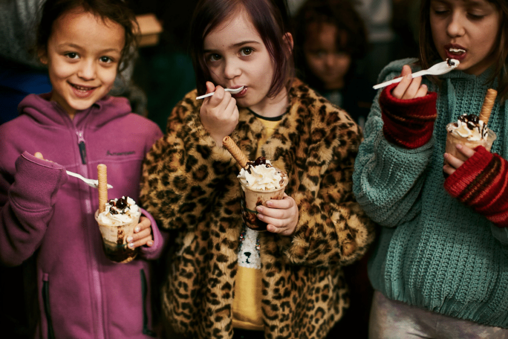 Three little girls enjoying ice cream at The Rink At Rising Food Hall