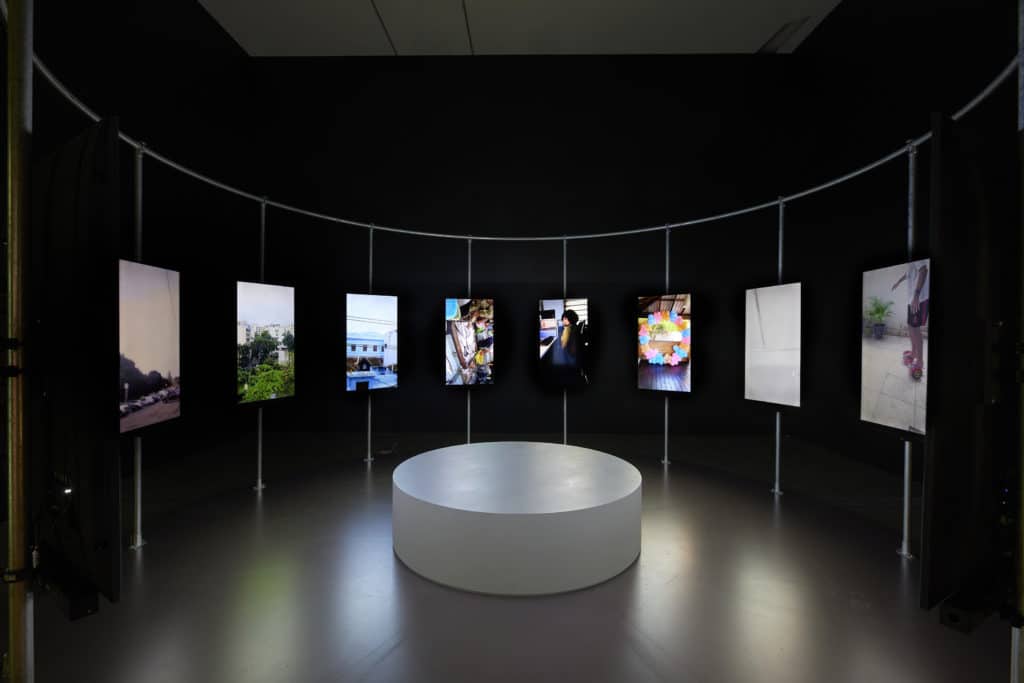 installation of view of one of the art exhibitions in melbourne of screens in front of a black wall