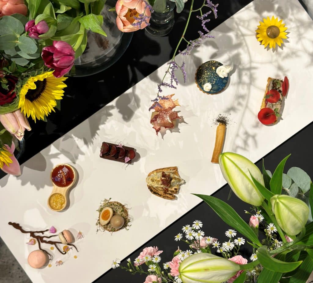 a selection of bites from Oxi Tea Room viewed from above among flowers