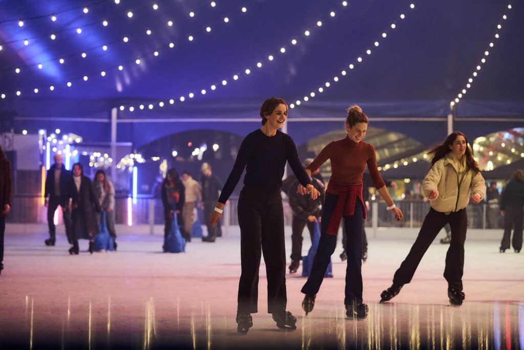 People ice skating at the rink at rising