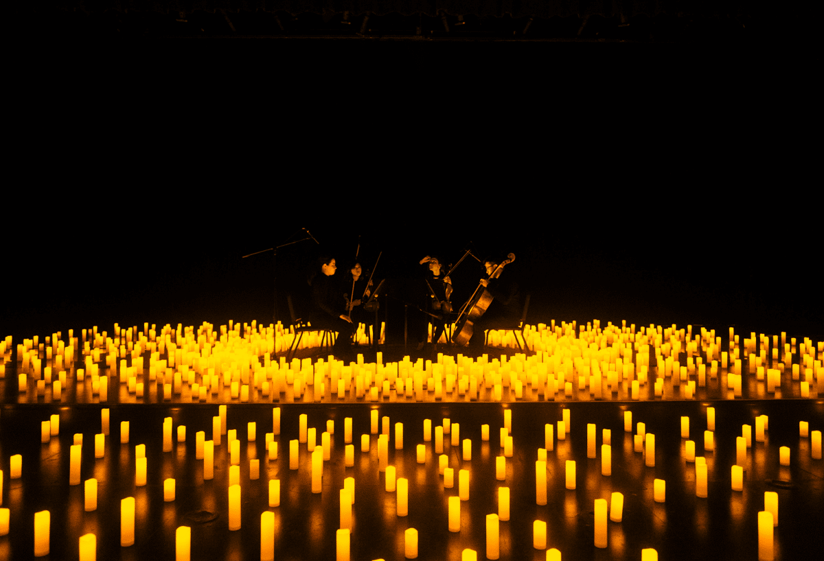 A string quartet performing in a sea of candles.