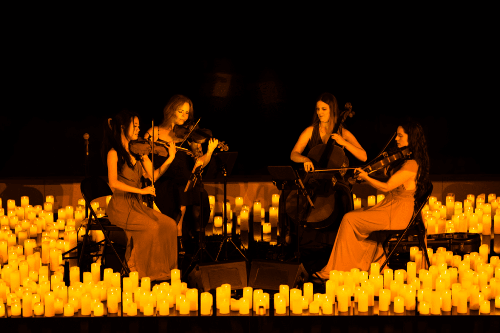 A string quartet performing amid a sea of candles.