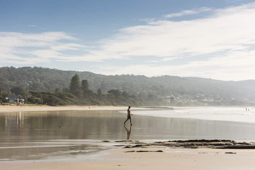 a person walking on the beach in Lorne