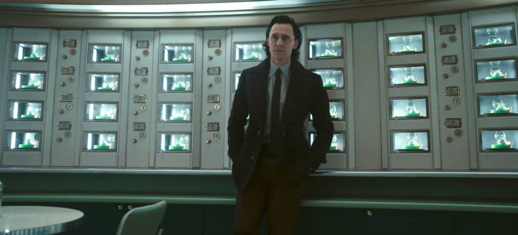 Loki standing in front of shelves of key lime pie, which you can try at Tarts Anon