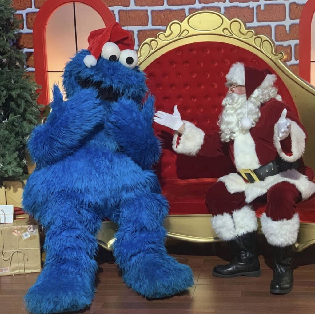 Santa on his chair and Cookie Monster with his hands over his mouth