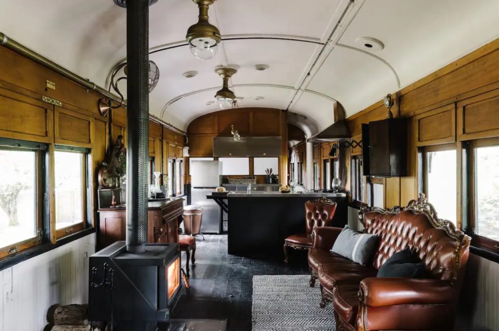 the living room area of the renovated steam carriage on Airbnb