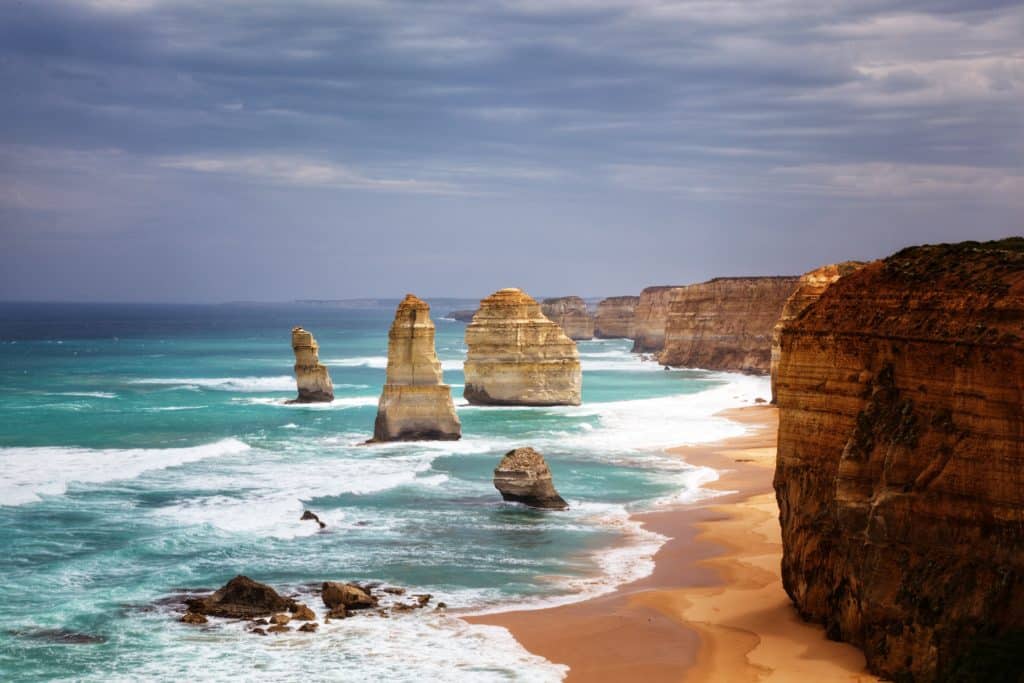 the famous Twelve Apostles rock formations, standing proudly against crashing waves, and in front of towering cliffs