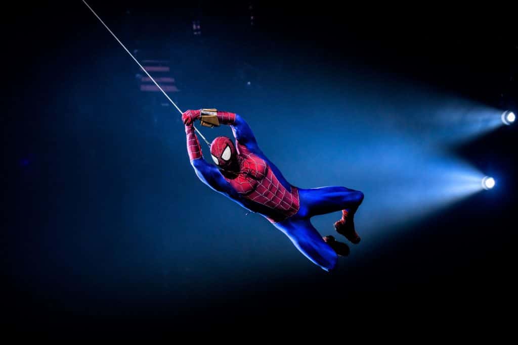 Spider-Man swinging on a web