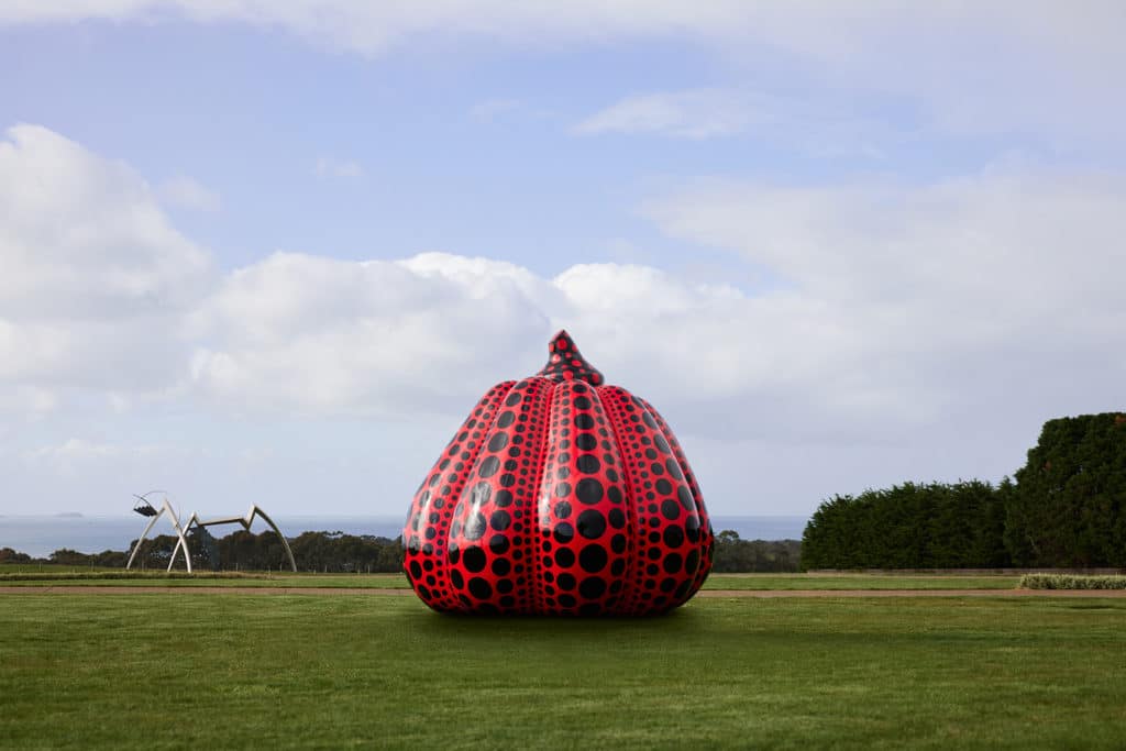 a large red and black pumpkin by Yayoi Kusama at Pt. Leo Estate Sculpture Park