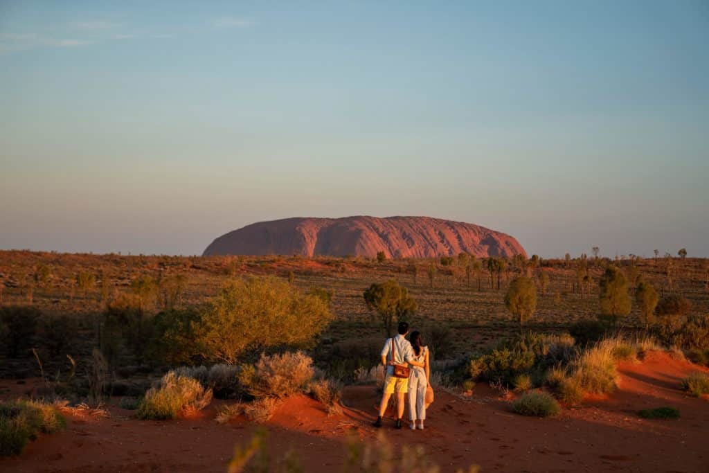 a couple looking at Uluru
